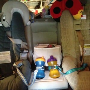 Neck pillows at the ready? Toys returned to a bin between carseats? Cups freshly filled and leashed? Yep, the backseat is ready to roll.