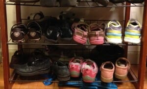 The bottom-most shelf on our just-inside-the-door shoe rack is where Essie's shoes go; the next shelf up is reserved for Kimmie's.
