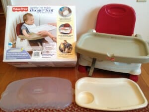 The deluxe model of the basic Fisher-Price seat costs only about $5 more, but comes with a detachable tray liner and cover, is height-adjustable, and takes up slightly less space in one's suitcase.