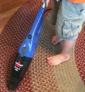 Essie vacuuming the kitchen floor