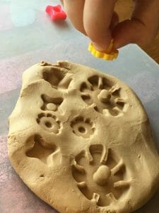 DIY fossil imprints from small toys in play-dough