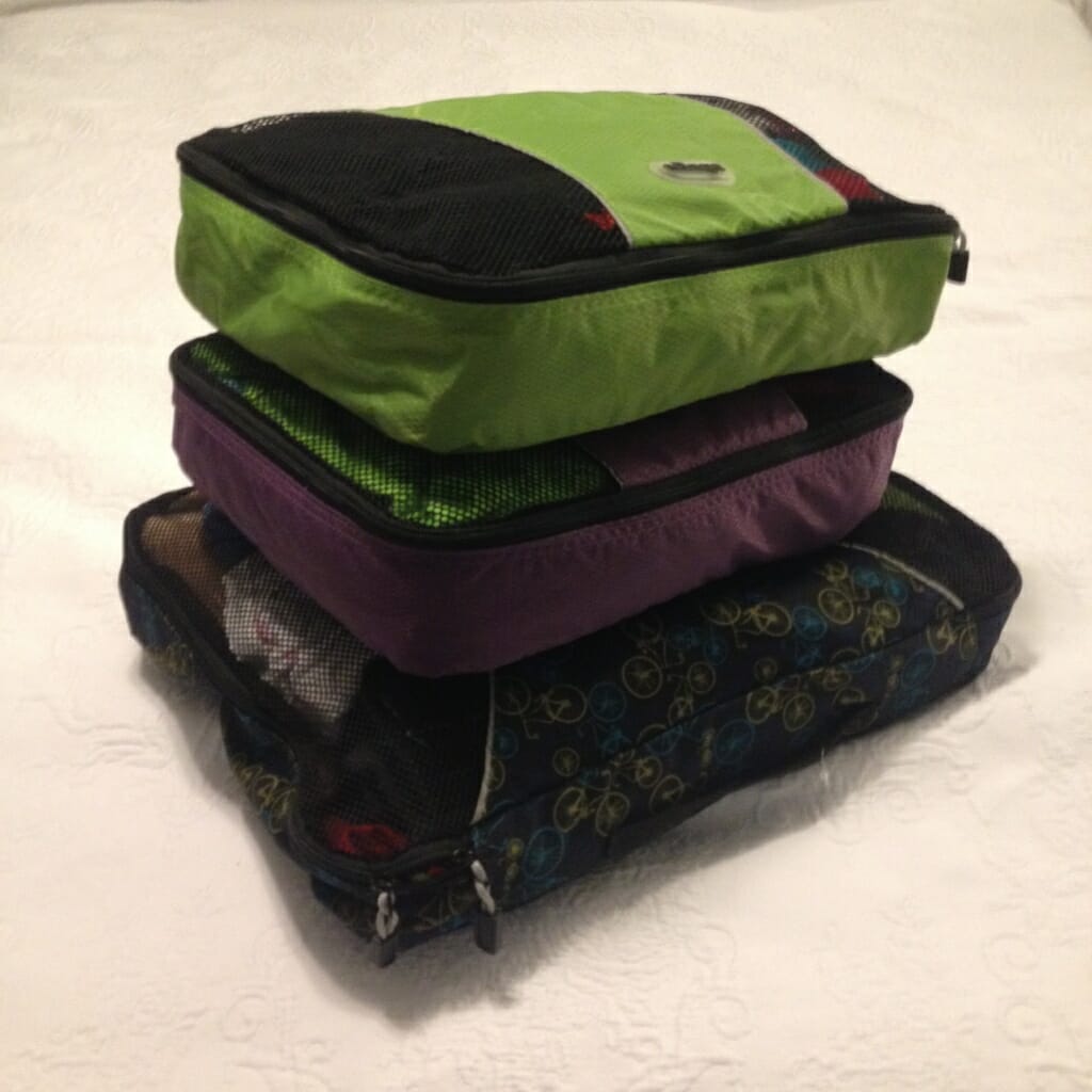 Despite the recent arrival of frigid winter temps, I still managed to pack enough warm layers for a five-day trip to my mom's in three packing cubes: a large one for me, and medium ones for each of the girls. To save space, we're wearing the bulkiest item when we travel.