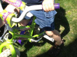 straddling bike with feet on ground