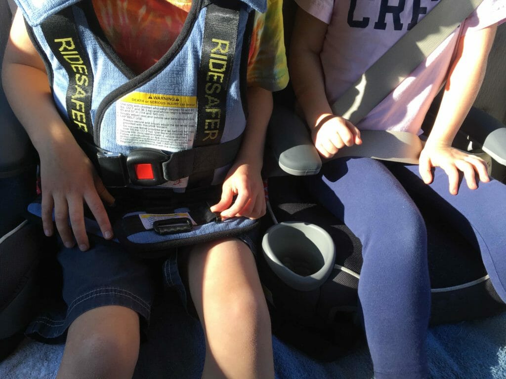 Six-year-old Kimmie fits comfortably in the middle spot of my back seat, wearing her RideSafer vest.