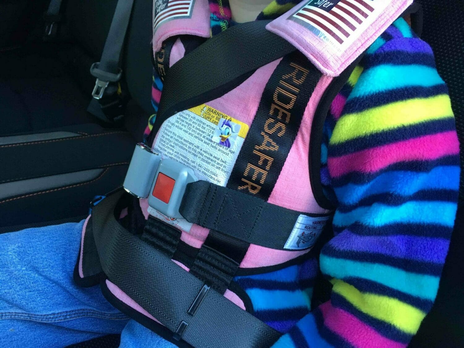 https://supermomhacks.com/wp-content/uploads/2016/11/wearing-RideSafer-vest-in-rental-car.jpg