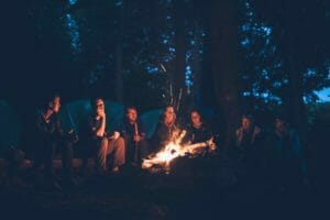 older kids enjoying a campfire at camp