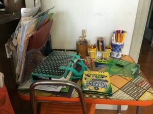 Before I made the girls a wall-mount art caddy, having their supplies on the table led to clutter everywhere.